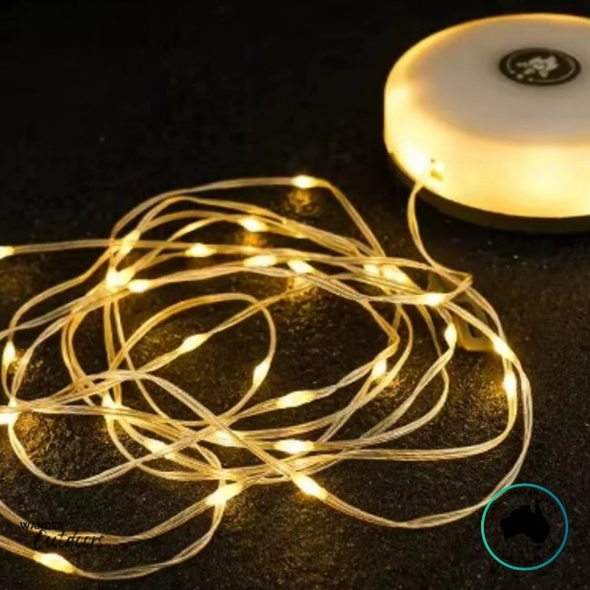 Dhubite retractable string lights laid out showing bright warm white light emitted evenly along the 10-metre cord.