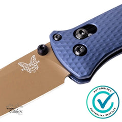 Close-up of a folding knife with a blue handle and brown blade, featuring the Benchmade logo.