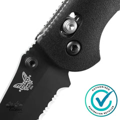 Close-up of a black folding knife with a visible brand logo and 'Authorized Australian Retailer' badge.