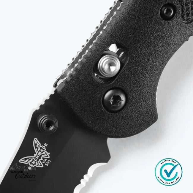 Close-up of a black folding knife with visible brand logo on a white background