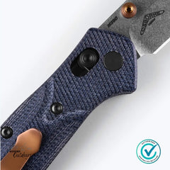Close-up of Benchmade 945-04 Mini Osborne handle showing denim micarta texture and copper pocket clip accents.