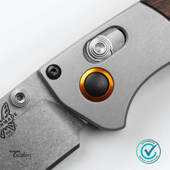 Close-up of a knife with a visible brand logo on a white background