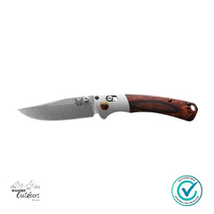 Folding knife with wooden handle on a white background