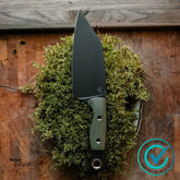 Benchmade B4010BK-01 Station Knife with black DLC CPM154 blade and OD/BK G10 handle resting on moss outdoors.