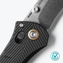 Close-up of Benchmade SEVEN | TEN handle showing AXIS Lock mechanism, bronze accent ring, and M390 steel blade marking