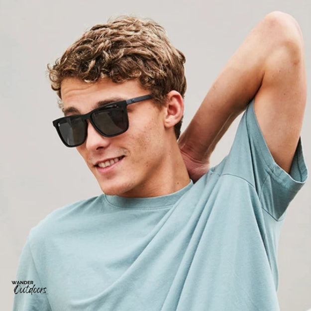 Unisex affordable Knockaround Fast Lanes Sport Sunglasses black on black male wearing outside
