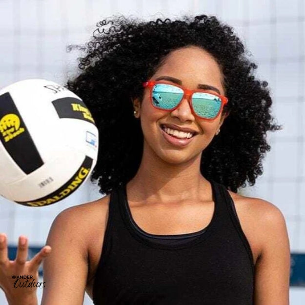 Unisex affordable Knockaround Fast Lanes Sport Sunglasses fruit punch aqua female wearing playing beach volleyball