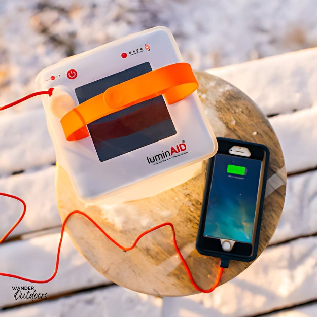 LuminAID PackLite Max 2-in-1 Power Lantern Charging in the Sun & charging phone