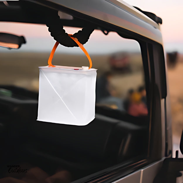 LuminAID PackLite Nova USB Solar Lantern in the car, charging in the elements