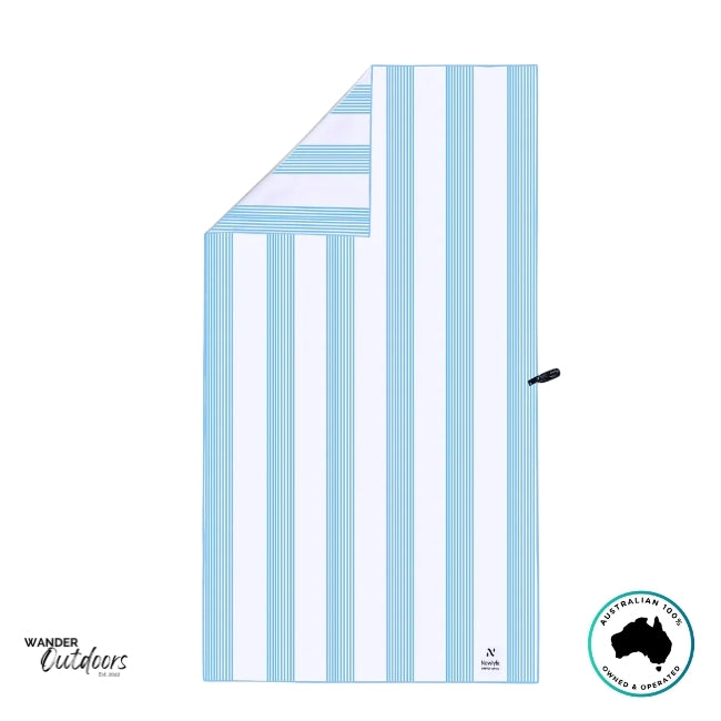 Flat lay of the Newlyfe Signature Calvi Sky Blue Towel with folded corner showing reversible stripe detail.