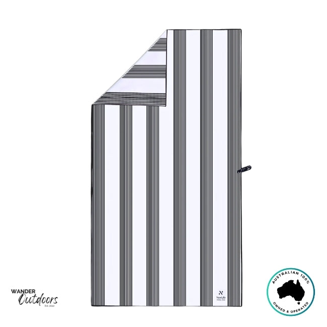 Flat lay of the Newlyfe Signature Santorini Black Towel with folded corner, showing clean stripe detail and stitched logo tag.