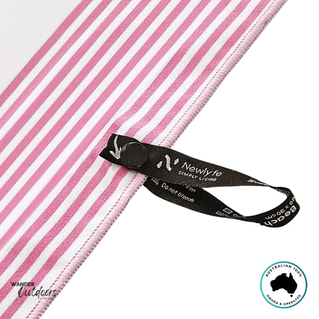 Close-up of black snap-lock hanging loop and woven branding tag on Newlyfe Signature Sanur Pink Towel.