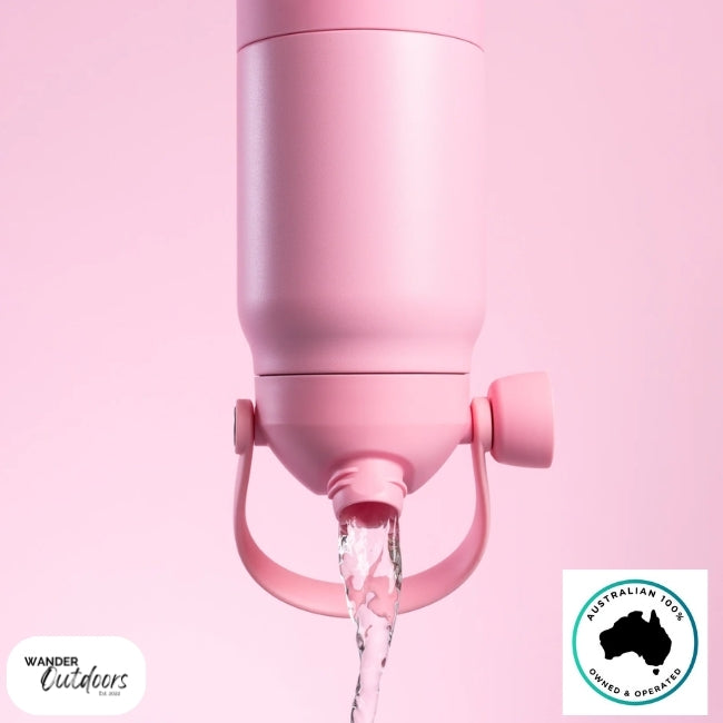 The Aussie Pal 1L Insulated Hydro Jug Water Bottle in pink product shoot with water chugging out