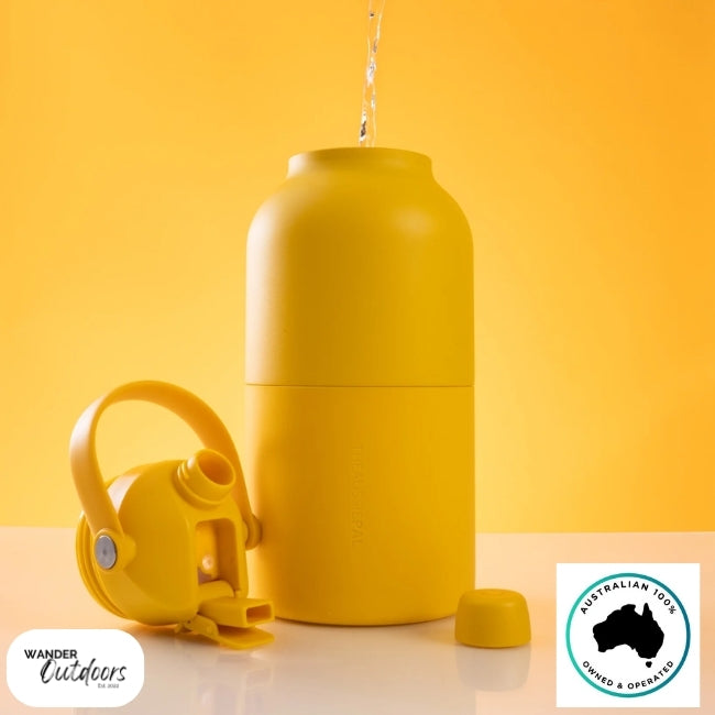 The Aussie Pal 2L Insulated Hydro Jug Water Bottle in Mango with dual lid off, being filled.