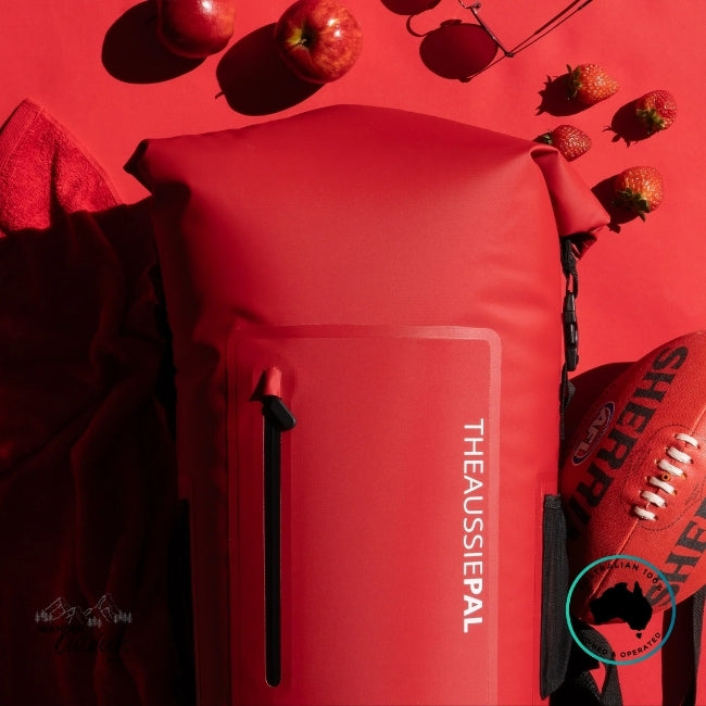 Red bag with 'The Aussie Pal' branding on a red background with apples and a football.