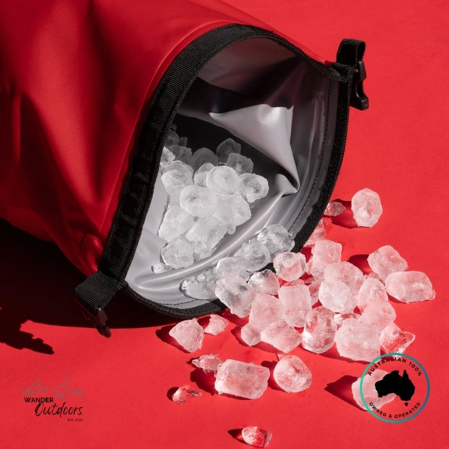 Red insulated bag with ice cubes spilling out on a red background, featuring Wander Outdoors branding.