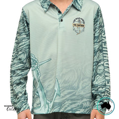 Front view of The Mad Hueys Croc Captain Youth UPF 50+ Fishing Jersey in faded dust, featuring front chest logo and all-over ocean pattern sleeves.