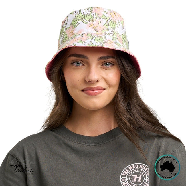 Woman wearing The Mad Hueys Galah Anchor reversible bucket hat and a gray t-shirt on a white background