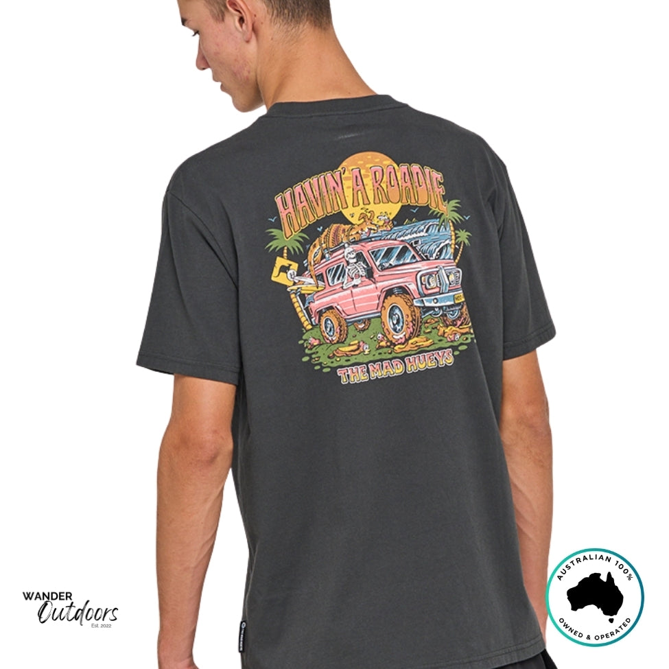 Back angled view of The Mad Hueys Roadie Tee showing full “Havin’ a Roadie” graphic featuring a ute, palm trees, and sunset scene.