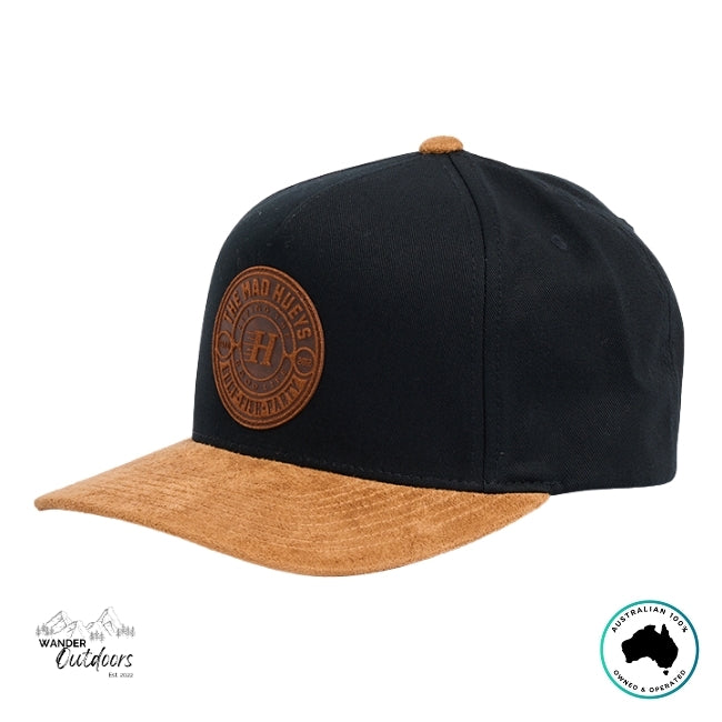 Black and brown cap with The Mad Hueys New Suede Logo on a white background