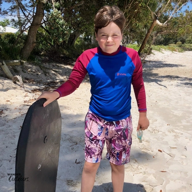 Heading out on the body board in thee surfs up rashie