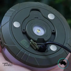 Close-up of Dhubite retractable string light base showing magnetic mounting points and USB-C charging cable connected.