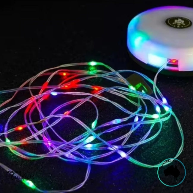 Dhubite retractable string lights displaying colourful RGB lighting mode with the reel glowing and cable spread out.