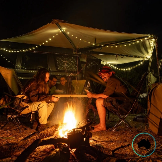 Warm white Dhubite retractable string lights hanging neatly under a vehicle awning, creating soft ambient camp lighting.