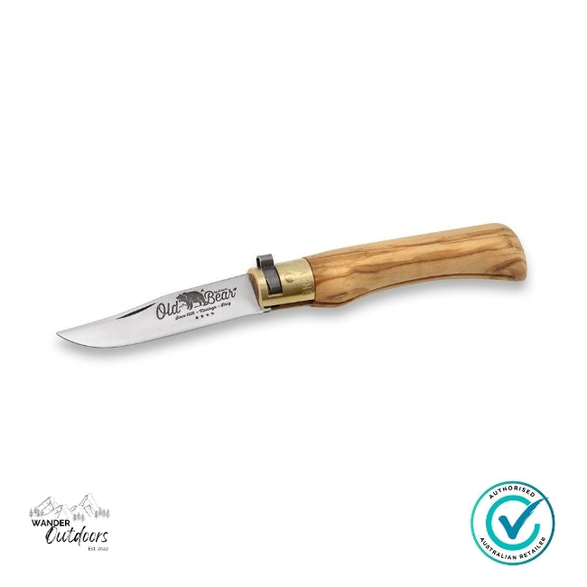Knife with wooden handle and brass clip on a white background