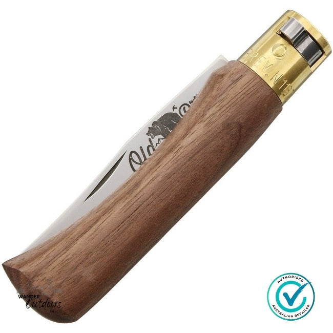 Wooden knife with gold blade on a white background