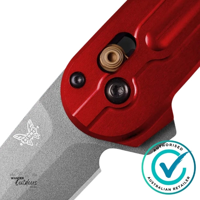 Close-up of Benchmade 491GY-01 Lowden knife showing grey Cerakote M390 blade and red anodised aluminium handle with AXIS Lock detail.