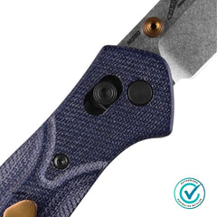 Close-up view of the Benchmade 940-04 Osborne showing the blue denim Micarta handle, Axis Lock mechanism and copper hardware details.