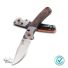 Folding knife with wooden handle on a white background