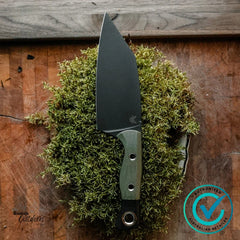 Benchmade B4010BK-01 Station Knife with black DLC CPM154 blade and OD/BK G10 handle resting on moss outdoors.