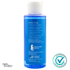 Blue bottle with white cap on a white background, featuring text and a logo.