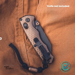 Folding knife on a brown leather surface with 'Knife not included' text and WANDR Outdoors branding.