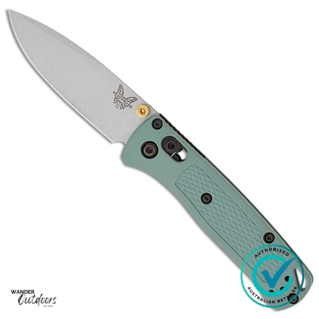 Folding knife with a green handle and silver blade on a white background