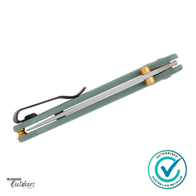 Green and silver folding knife with gold accents on a white background, featuring Wander Outdoors branding.