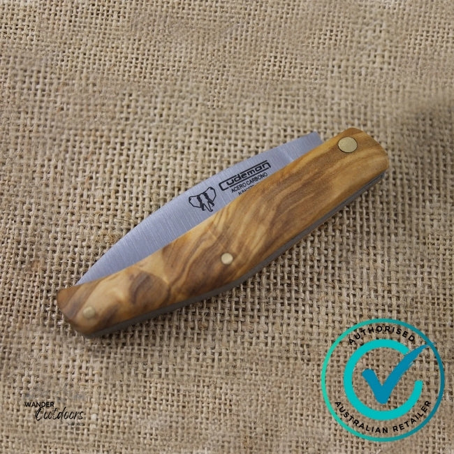 Foldable knife with wooden handle on a burlap background