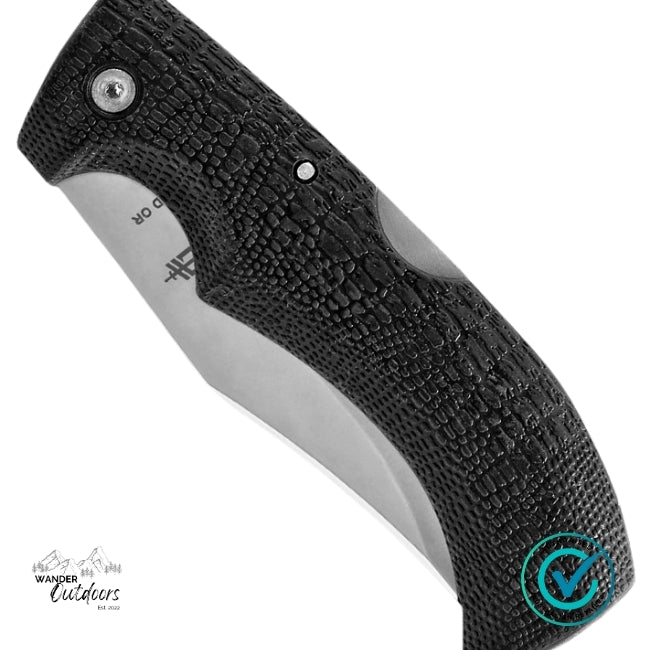 Close-up of a folding knife with textured black handle and blade on a white background