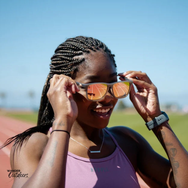 Unisex affordable Knockaround Fast Lanes Sport Sunglasses jelly grey peach female runner wearing on athletics track