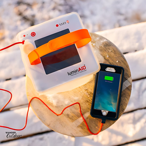 LuminAID PackLite Max 2-in-1 Power Lantern Charging in the Sun & charging phone 