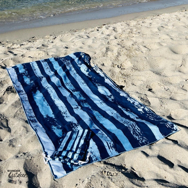 Newlyfe Beach Towel & Pouch Trigg flat lay on sand