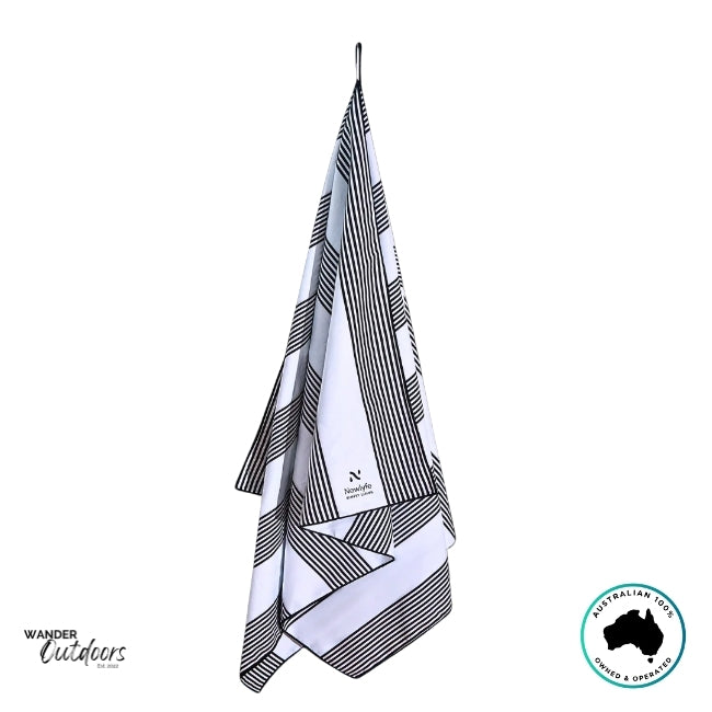 Newlyfe Signature Santorini Black Towel hanging from loop to show lightweight, quick-dry design.