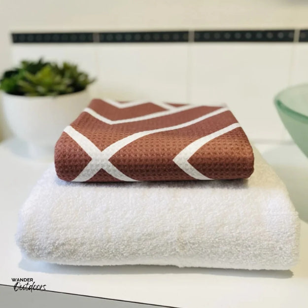 Newlyfe Waffle Weave Bath Towel Rust Compact folded on bulky cotton towel