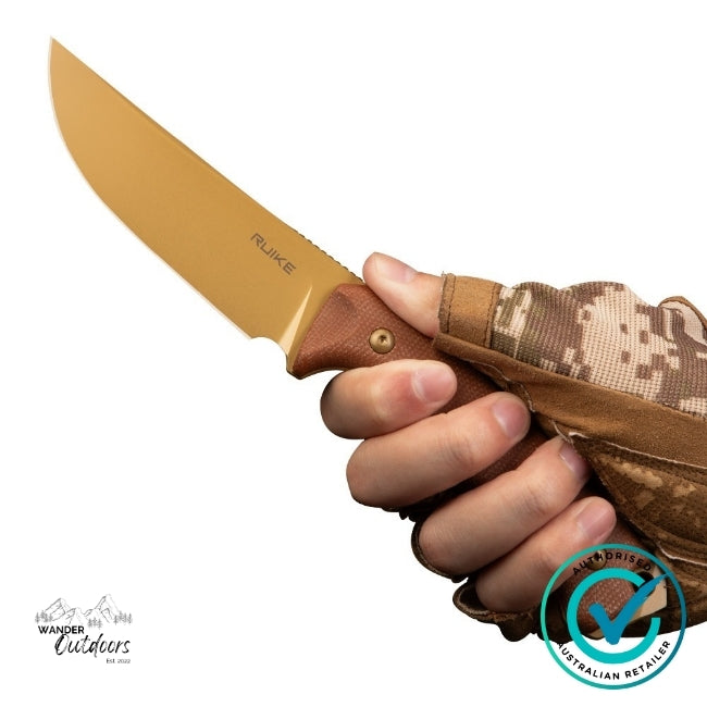 Close-up of the Ruike F186-MN Fixed Blade Knife held in a gloved hand, showing the tan D2 steel blade and textured Micarta handle — built for dependable outdoor use.