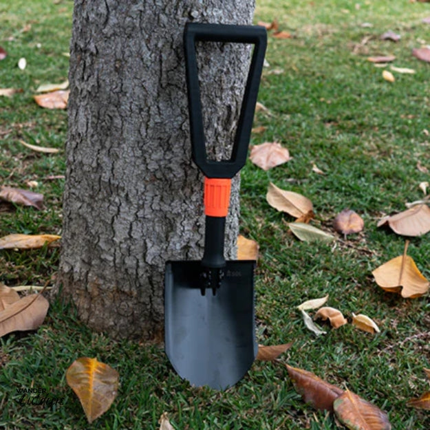 SOL Packable Field Shovel Against A Tree