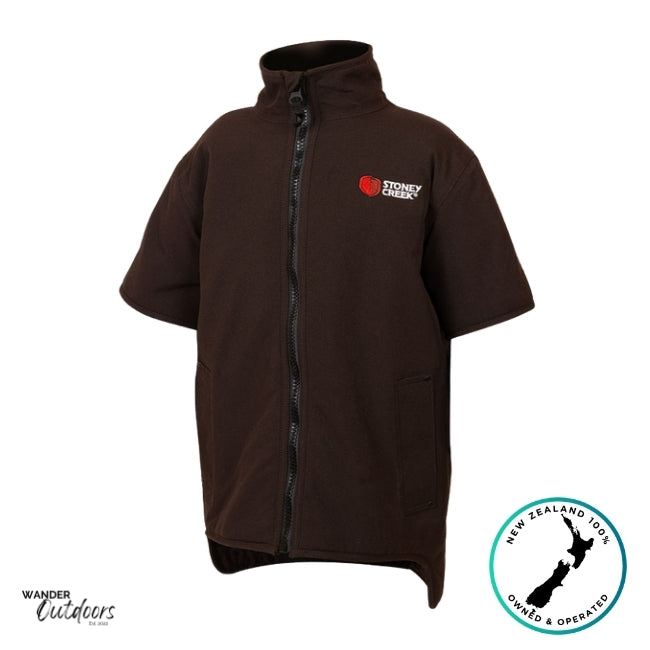 Product photo of the Stoney Creek Kids Rammer Jacket in dark brown with short sleeves, full-length front zipper, and embroidered red logo on the chest. Plain white background with Wander Outdoors and New Zealand Owned & Operated badges.