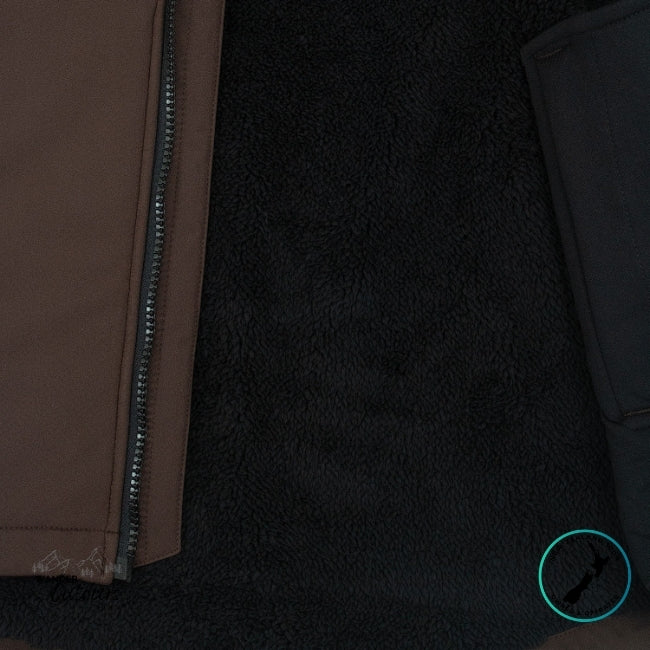 Close-up of a brown jacket with a zipper on a dark textured background