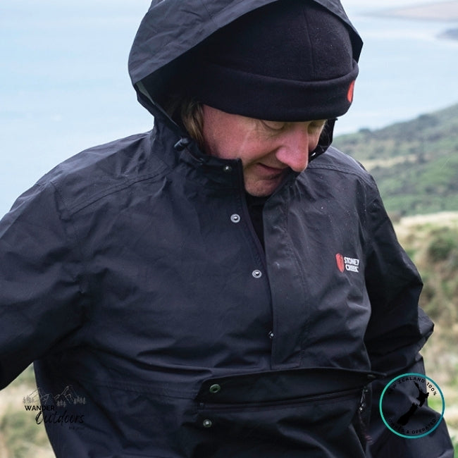 Person wearing a Stoney Creek Recreational (Stow it) Jacket in Black, standing outdoors.